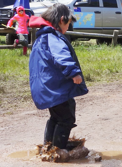Overland Expo West 2015 Kid Jumping in Mudpuddle